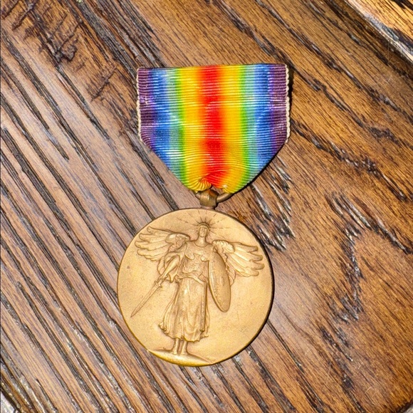 Veterans Day honors all of those who have served the country  Vintage Gold Medal with Rainbow Ribbon